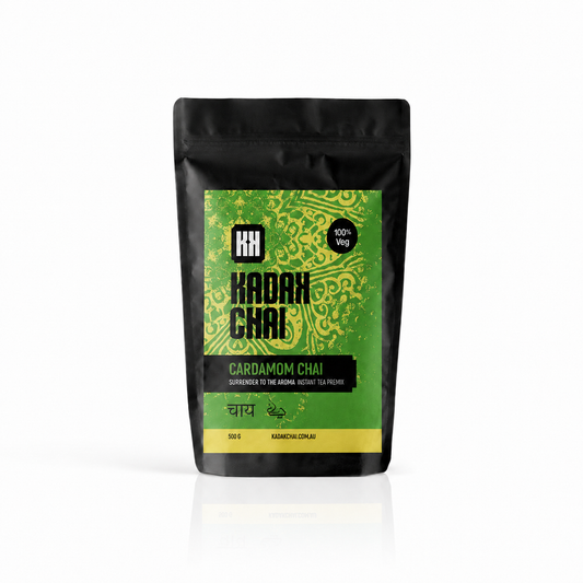 A 500g stand-up pouch of Kadak Chai Cardamom Chai tea, featuring a black packaging design with a prominent green and yellow patterned label.